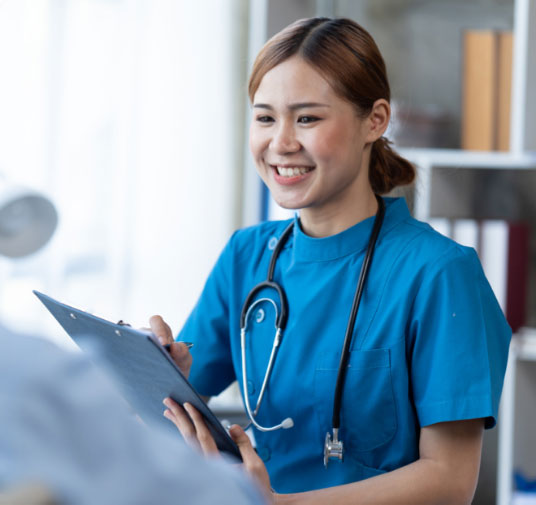 Doctor smiling with paperwork